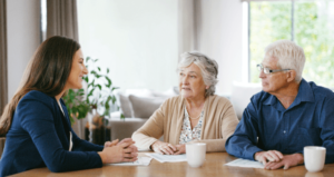 A mesothelioma lawyer meeting with an elderly couple