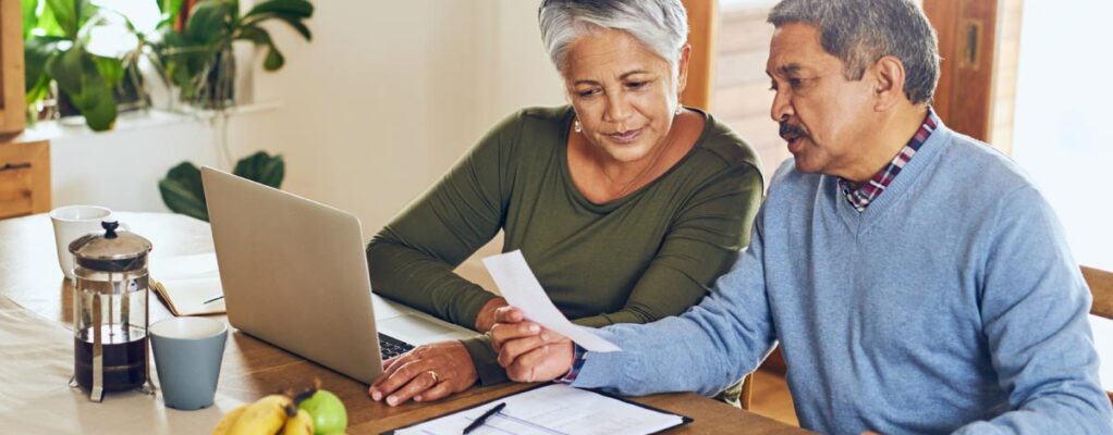An elderly couple reading health care information