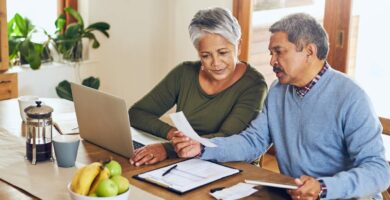 An elderly couple reading health care information