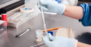 Scientist preparing a fluid sample for analysis in the laboratory