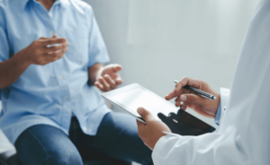A patient speaks with their doctor about mesothelioma clinical trials