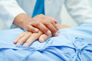 A health care provider comforts a patient