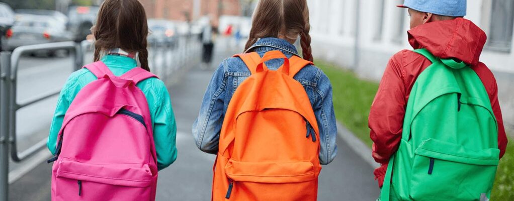 Three children wearing backpacks