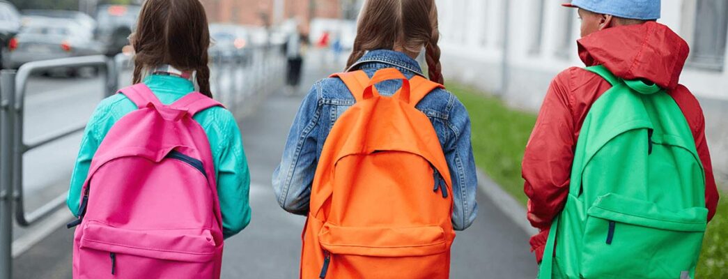 Three children wearing backpacks