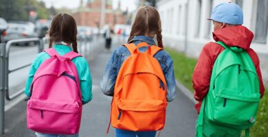 Three children wearing backpacks