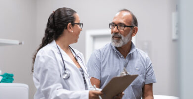 Doctor talking to patient holding clipboard