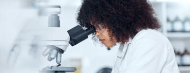 Researcher looking in microscope