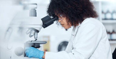 Researcher looking in microscope