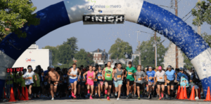 Runners cross the finish line at the 2023 Miles for Meso event in Alton, Illinois