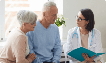 Elderly couple talking to nurse