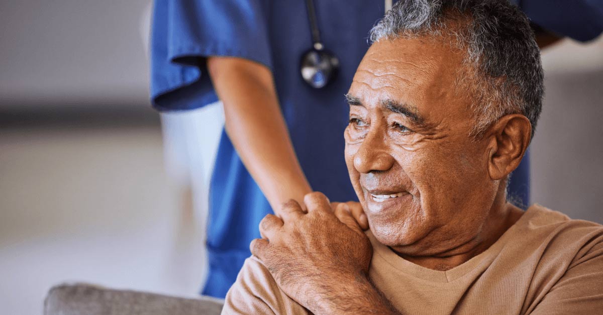 A doctor puts her hand on a patient's shoulder