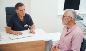 A patient discusses pleural mesothelioma surgery with his doctor