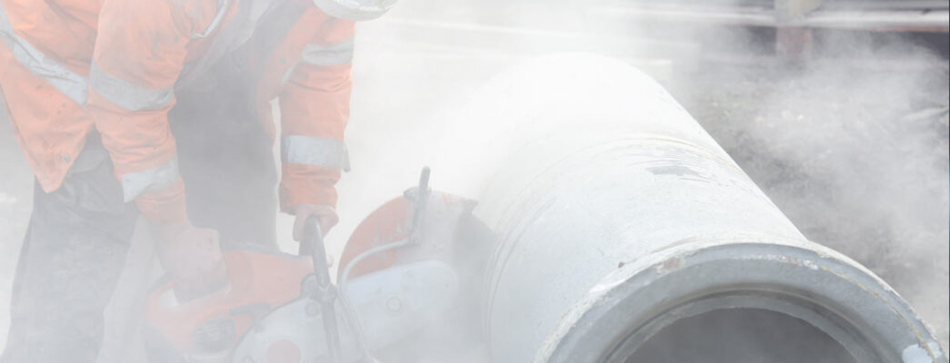 worker cutting asbestos-containing pipes