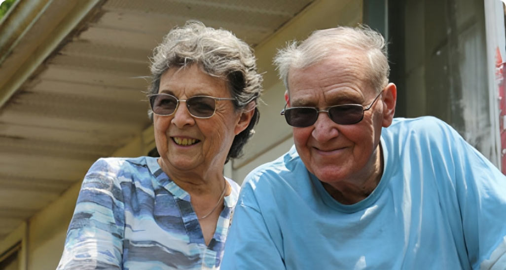 Mesothelioma survivor Arthur and his wife Jan smiling with their lawyer