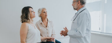 A doctor speaks with an elderly patient and her family member