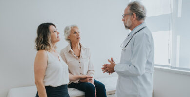 A doctor speaks with an elderly patient and her family member