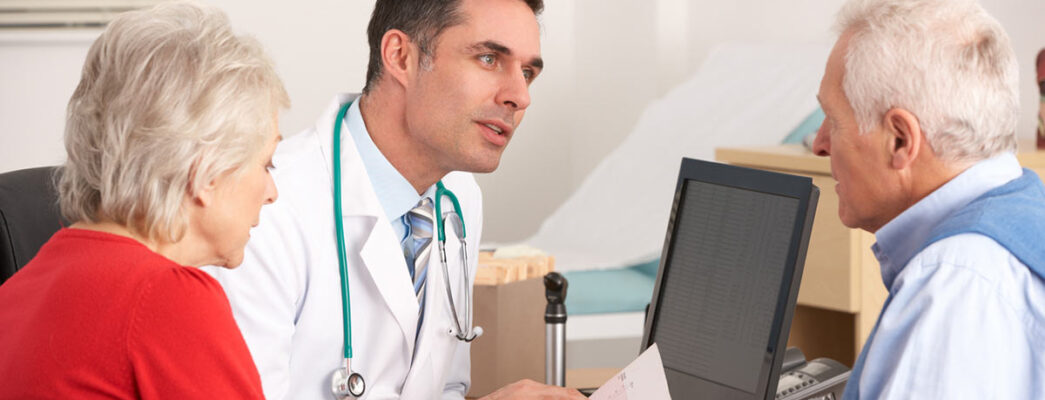 Mesothelioma doctor talking to an older male patient and his wife