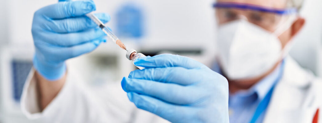 Scientist using a syringe in a laboratory