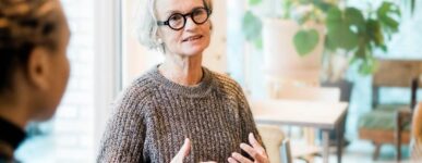 An older woman speaks in a support group