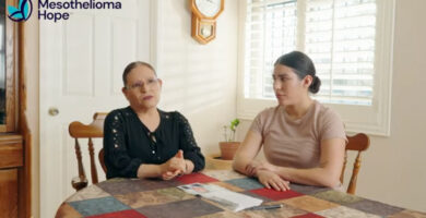 Two members of Oscar Avila's family sit at their dining room table