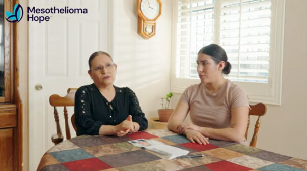 Two members of Oscar Avila's family sit at their dining room table