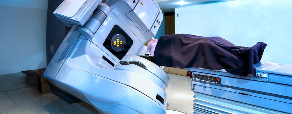 Patient lies on their back under a linear accelerator machine