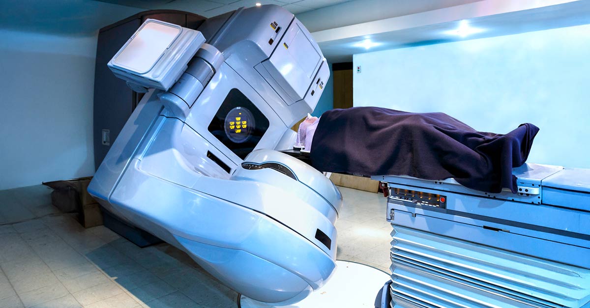Patient lies on their back under a linear accelerator machine