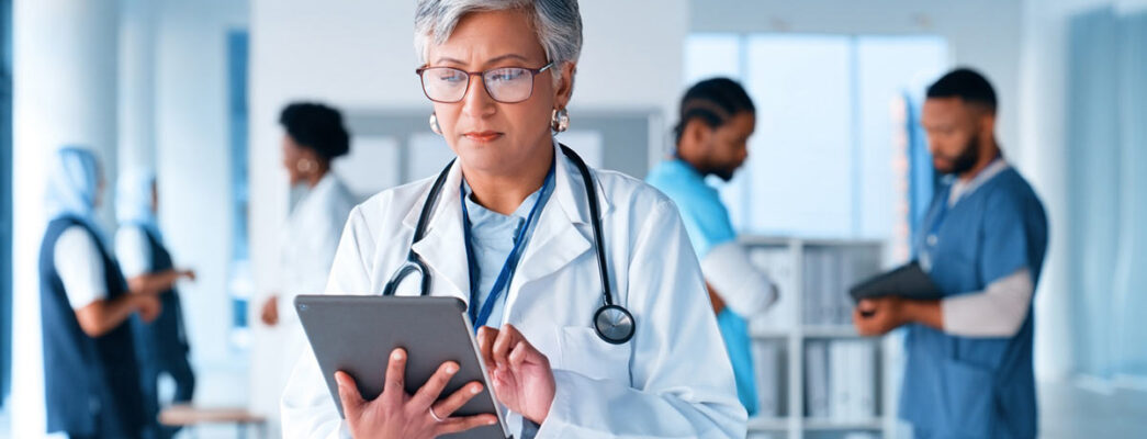 Doctor reviewing data on a tablet in a hospital