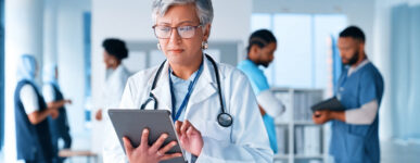 Doctor reviewing data on a tablet in a hospital
